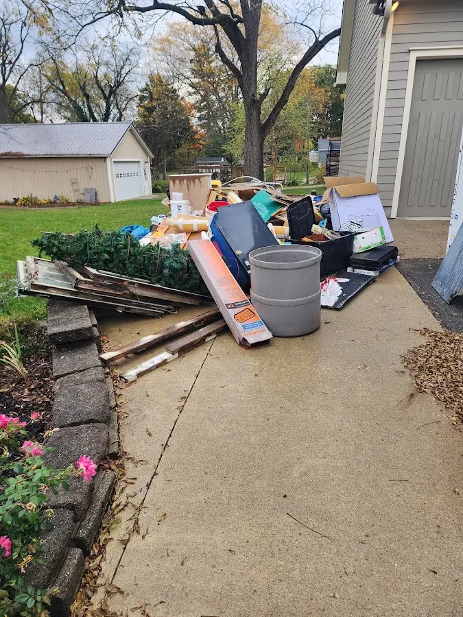 Dumpster being loaded with debris for 12 Yard Dumpster Rental in Barrington Hills